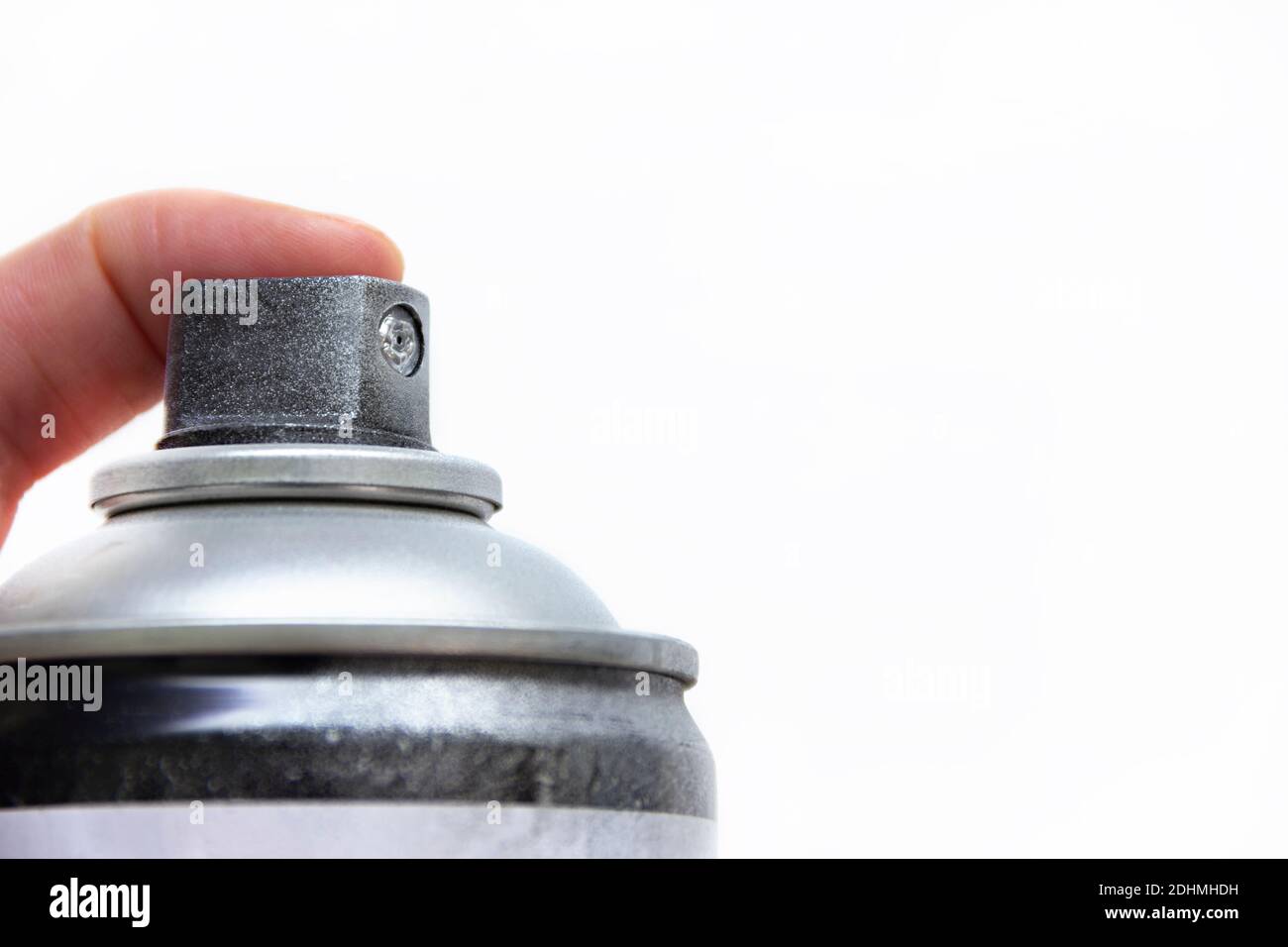 Human hand holding a graffiti Spray can, closeup view of upper part of can Stock Photo