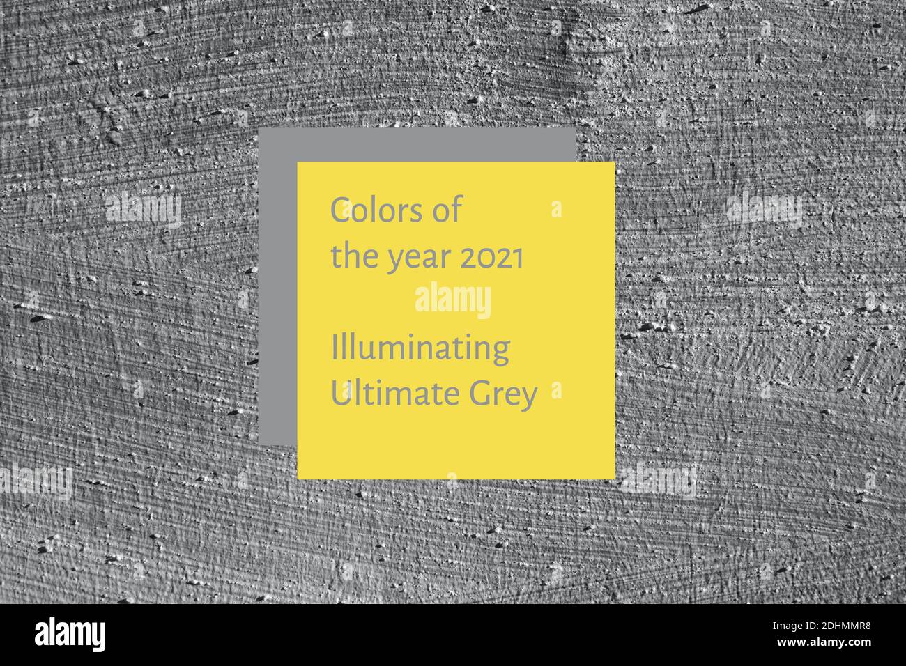Background of grey smooth concrete wall with yellow and grey square. Concept of colors of year 2021. Stock Photo