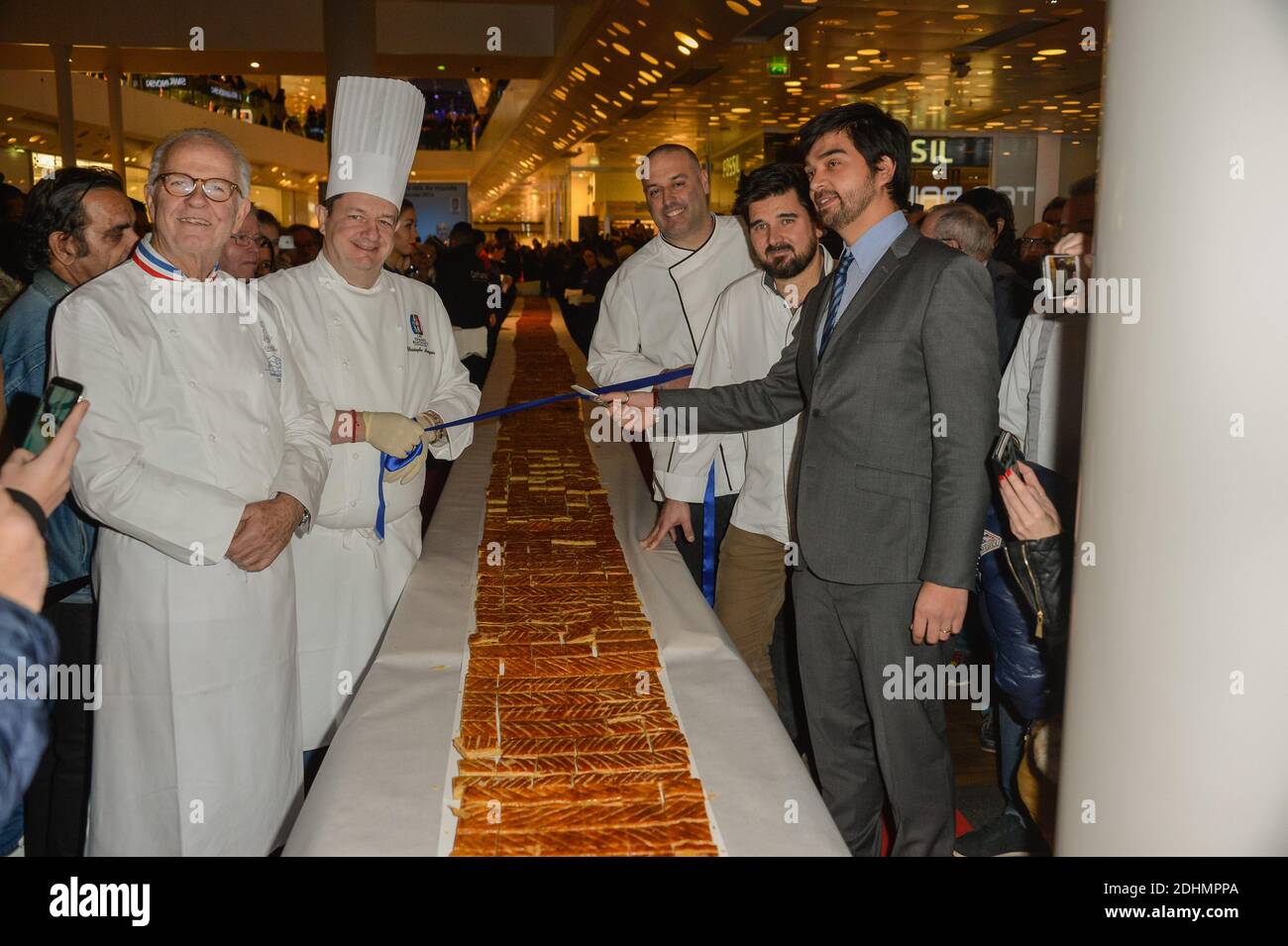 French chefs Jean-Paul Pignol, Christophe Marguin, Philippe Bernachon and  Sebastien Bouillet pose along with mall director Jeremy Desprets during the  presentation of the world's biggest Epiphany cake at Confluence shopping  mall in