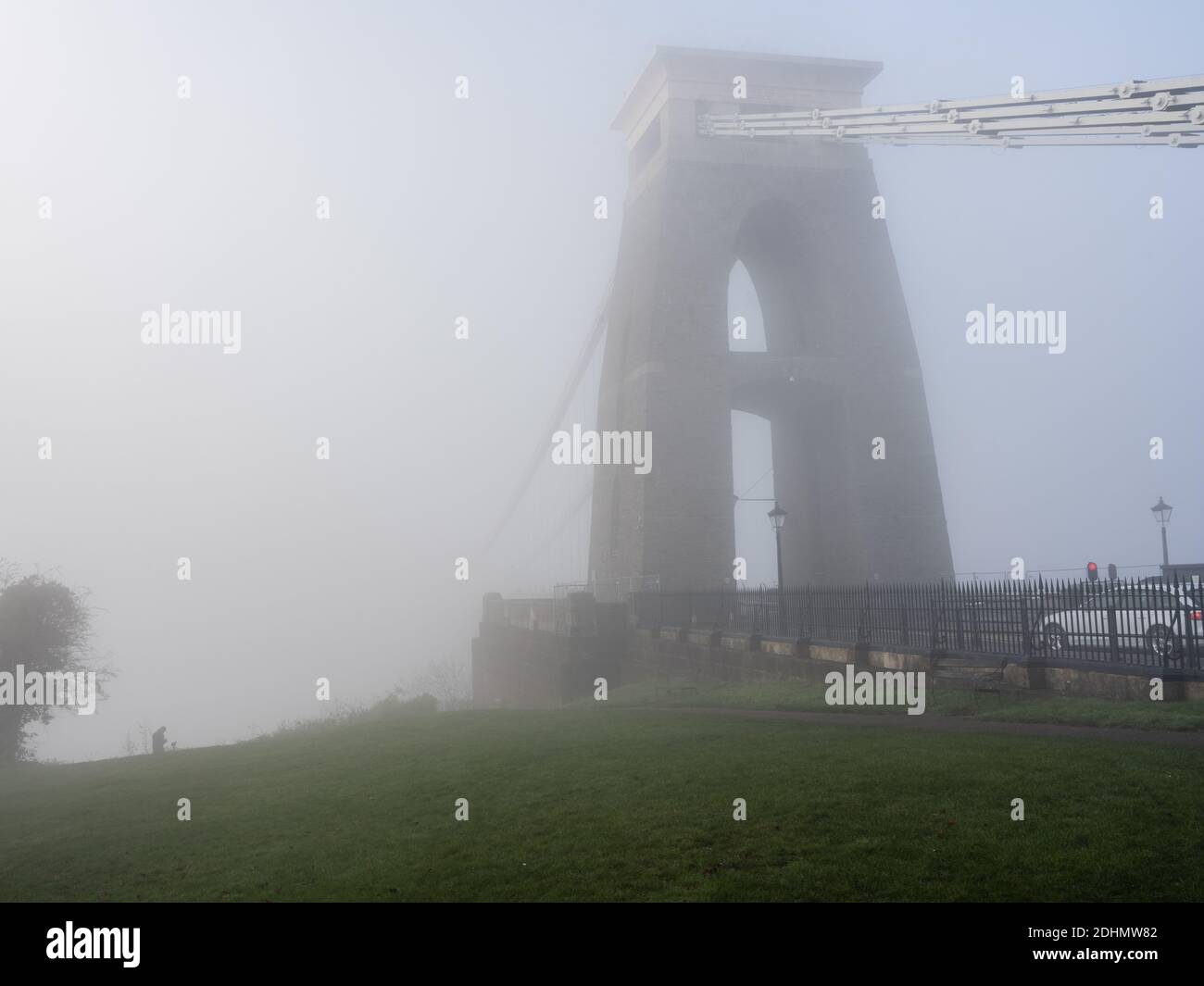 The landmark Clifton Suspension Bridge disappears into a shroud of fog during autumn on Bristol's Clifton Down. Stock Photo