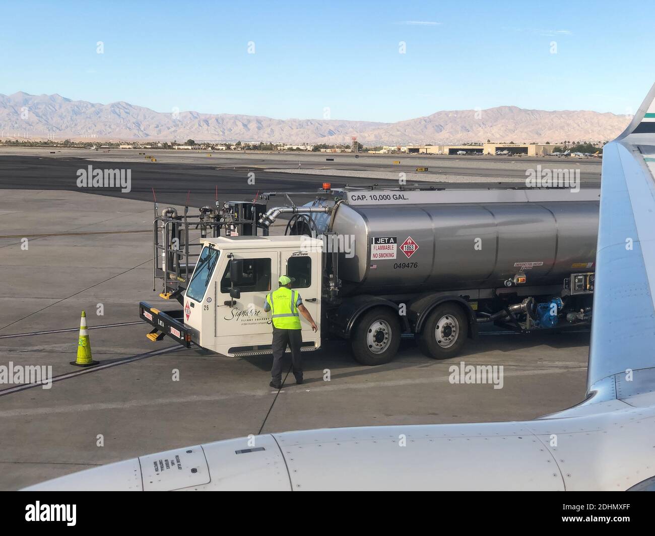 Palm Springs, USA. 22th, Nov 2020. A Signature Flight Support Jet Fuel truck refilling an Alaska Airlines jet. Stock Photo