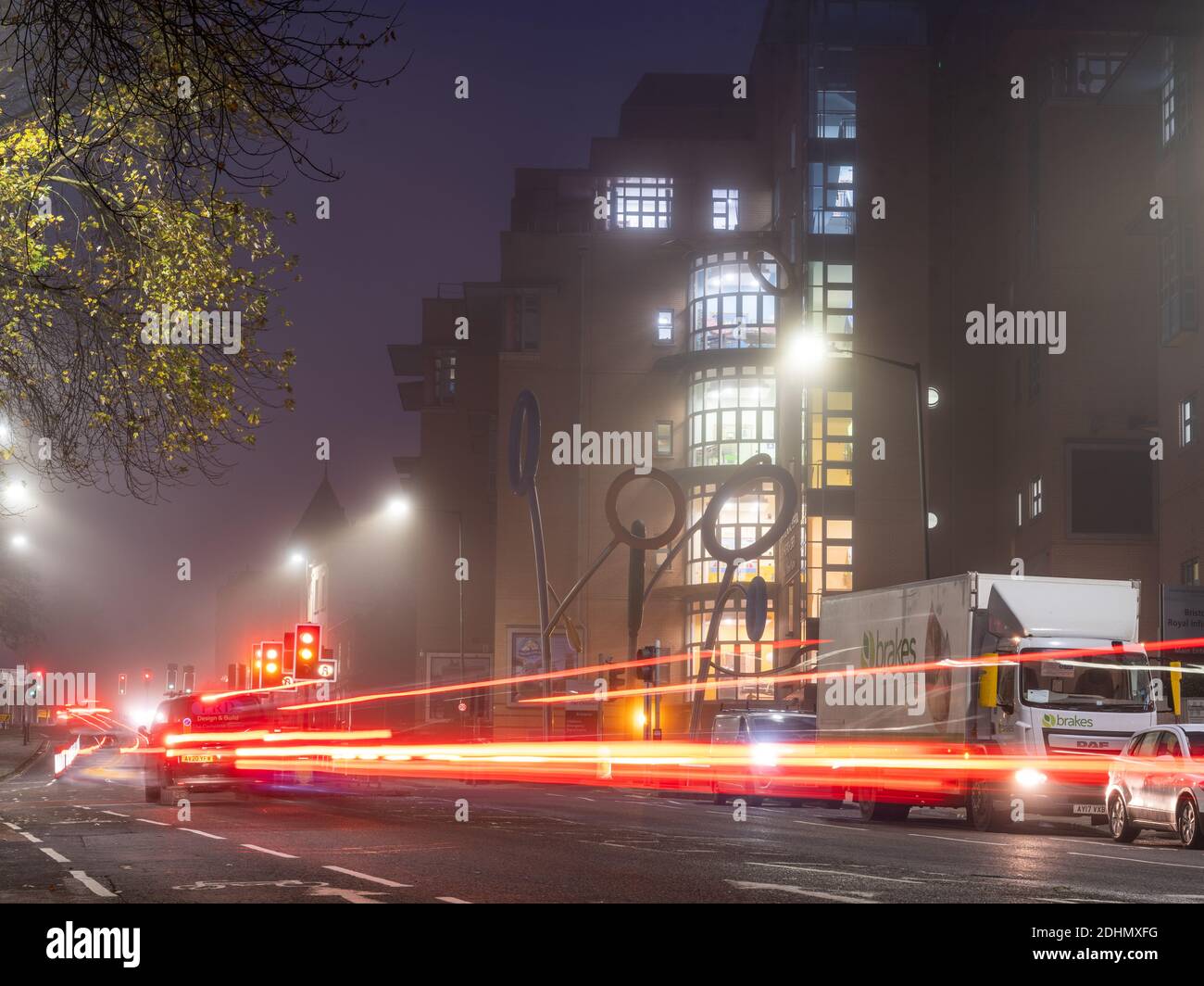 Bristol Children's Hospital is lit on a misty night on Upper Maudlin Street. Stock Photo