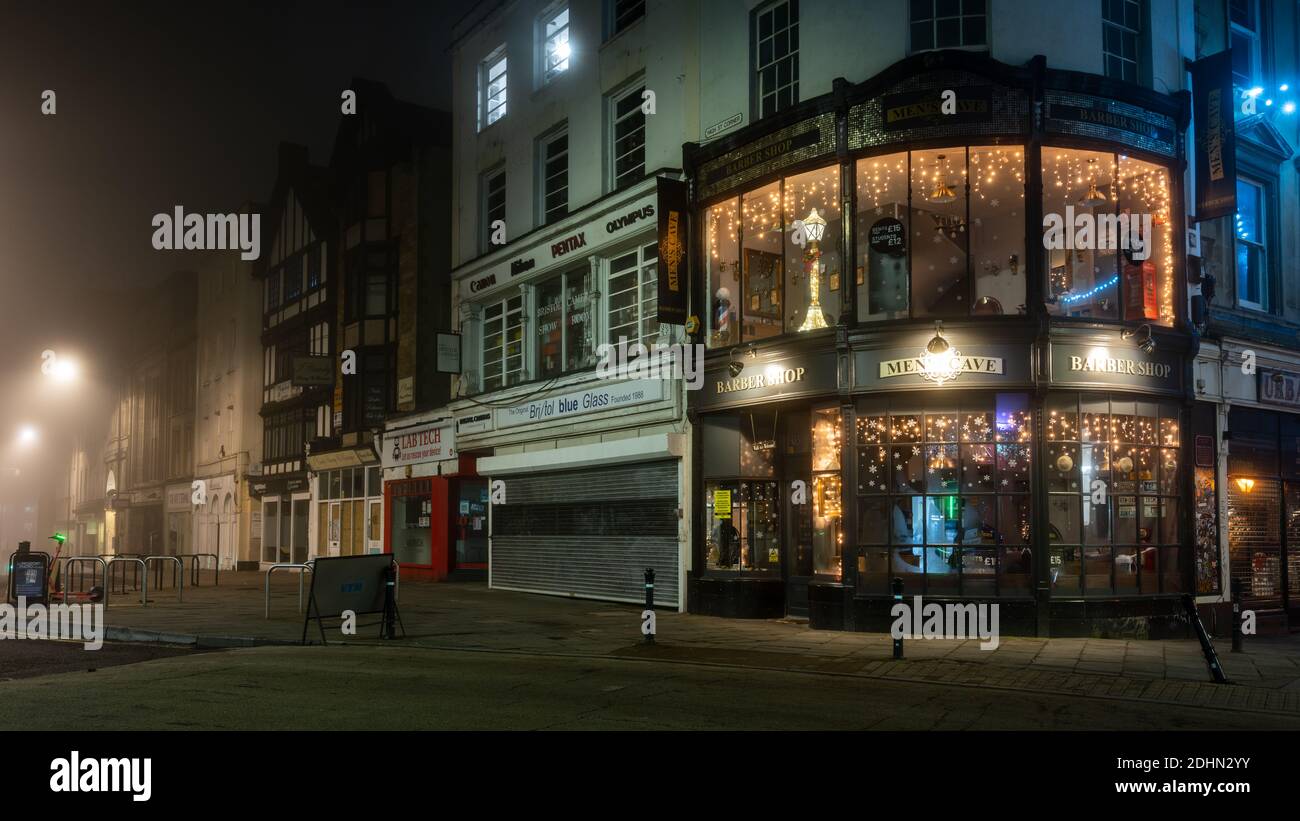 Shops are decorated for Christmas at High Street Corner on a misty