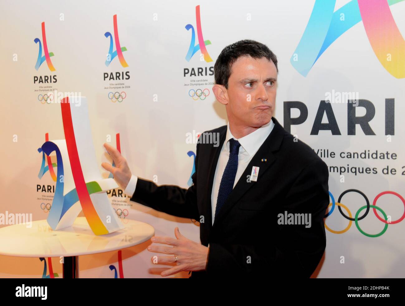 French Prime Minister Manuel Valls poses with the logo of Paris as
