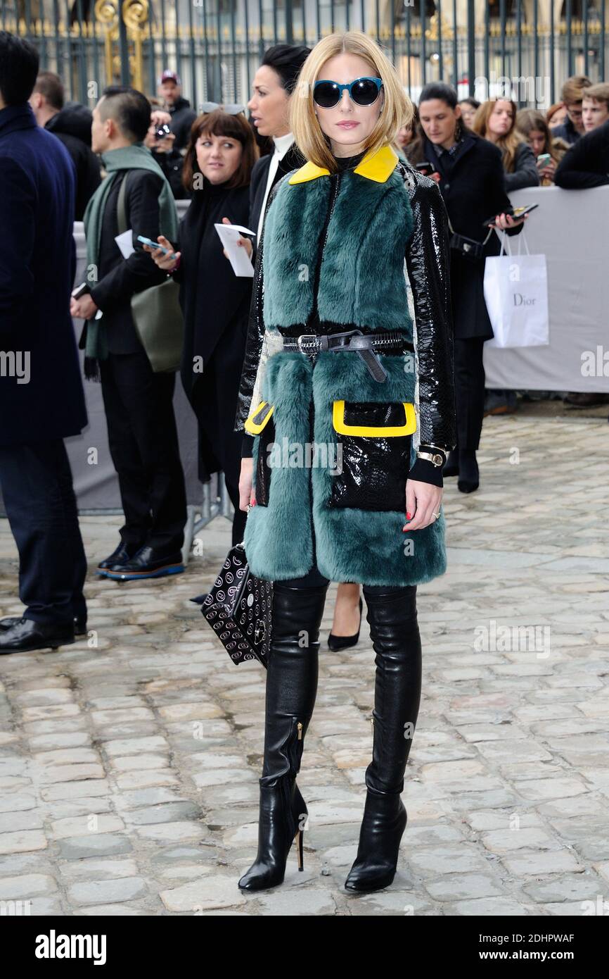 A guest wears a gray fur coat, and a Diorama bag from Dior, outside