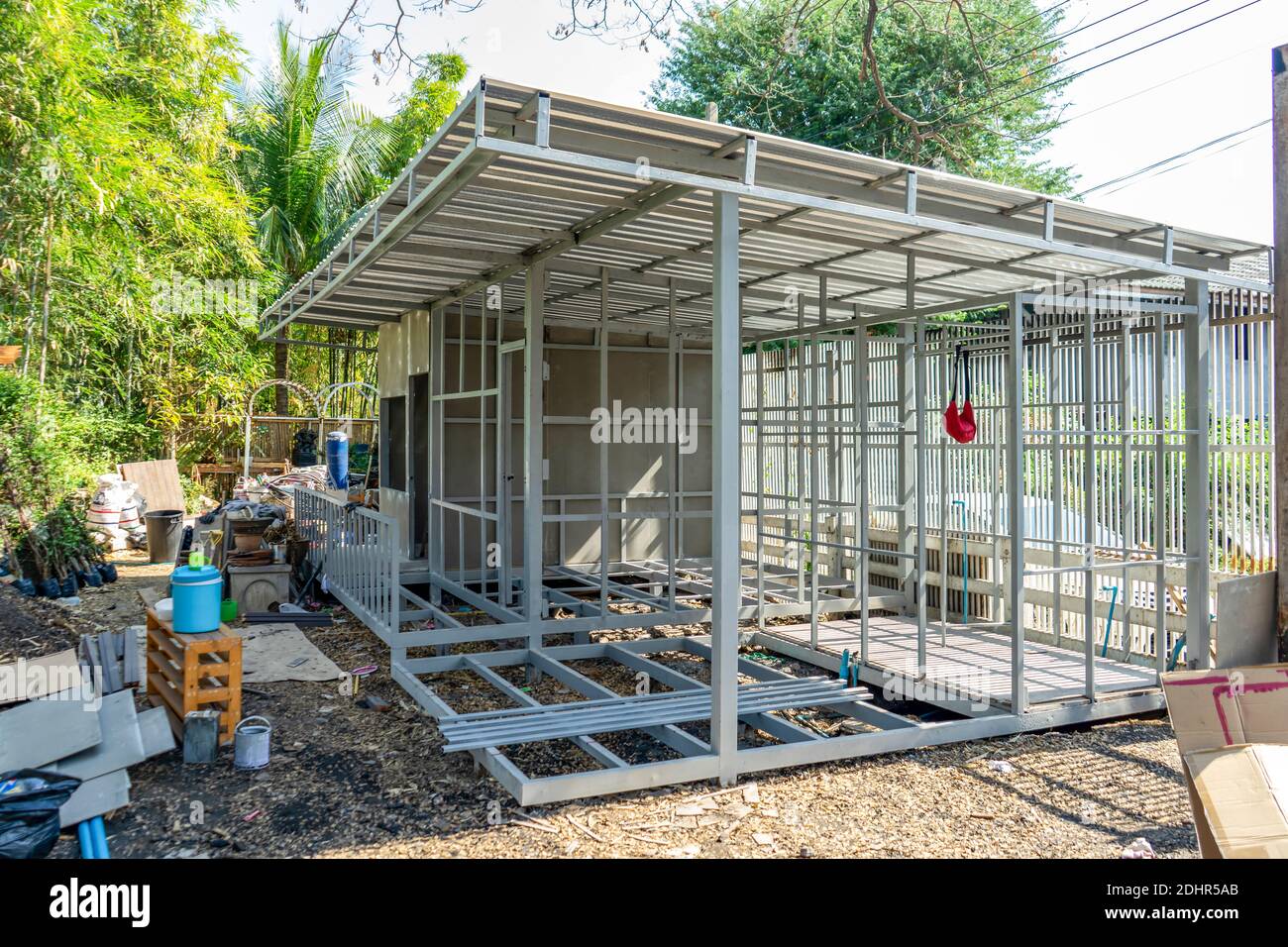 underconstruction housemaid small temporary home is made from steel pole  structure without cement and brick with garden and fence around Stock Photo  - Alamy, image size:1300x956