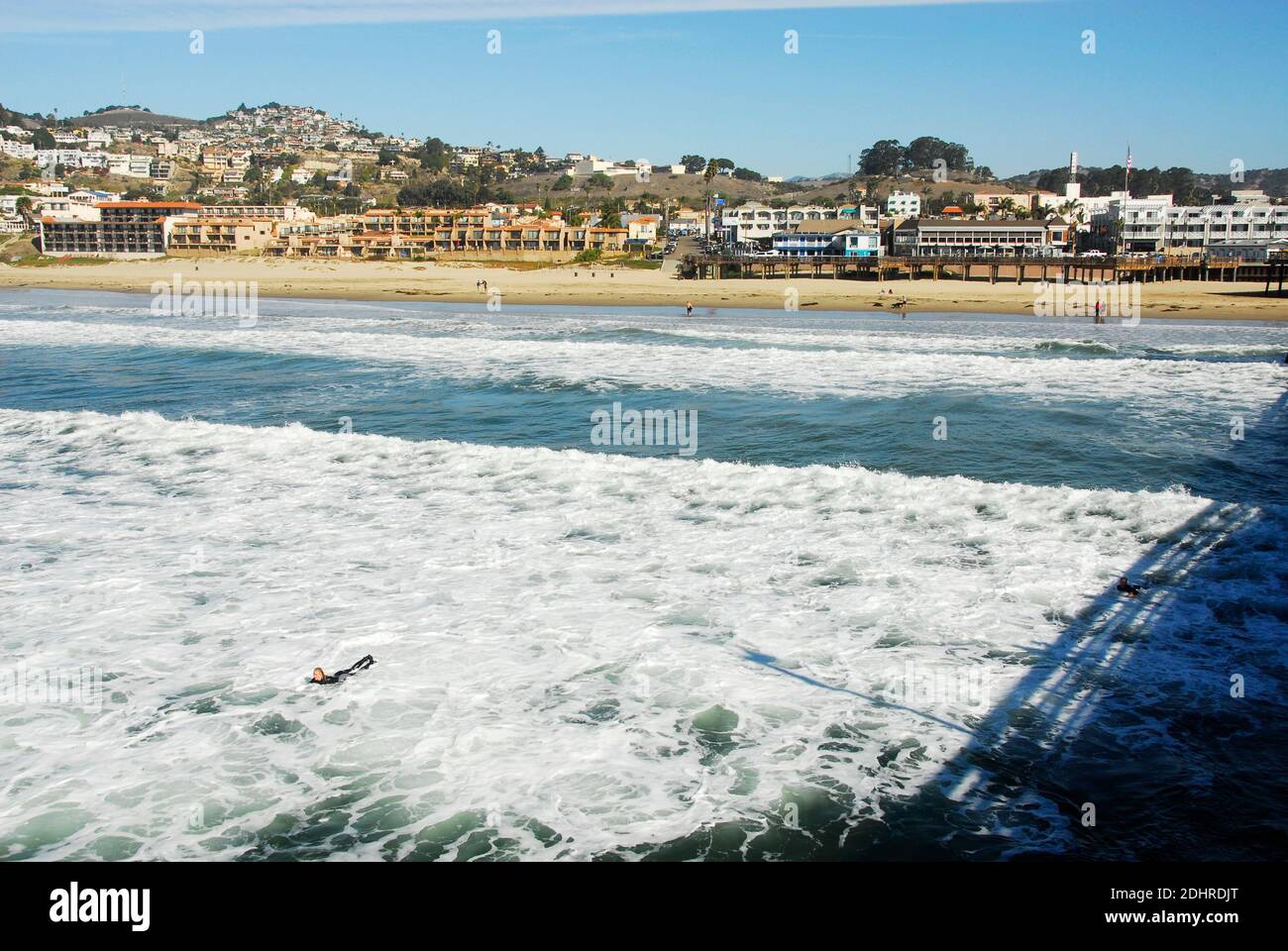View of the town from the pier of Pismo Beach in San Luis Obispo County, California, famous for its Pismo Clams, beaches, and sand dunes. Stock Photo