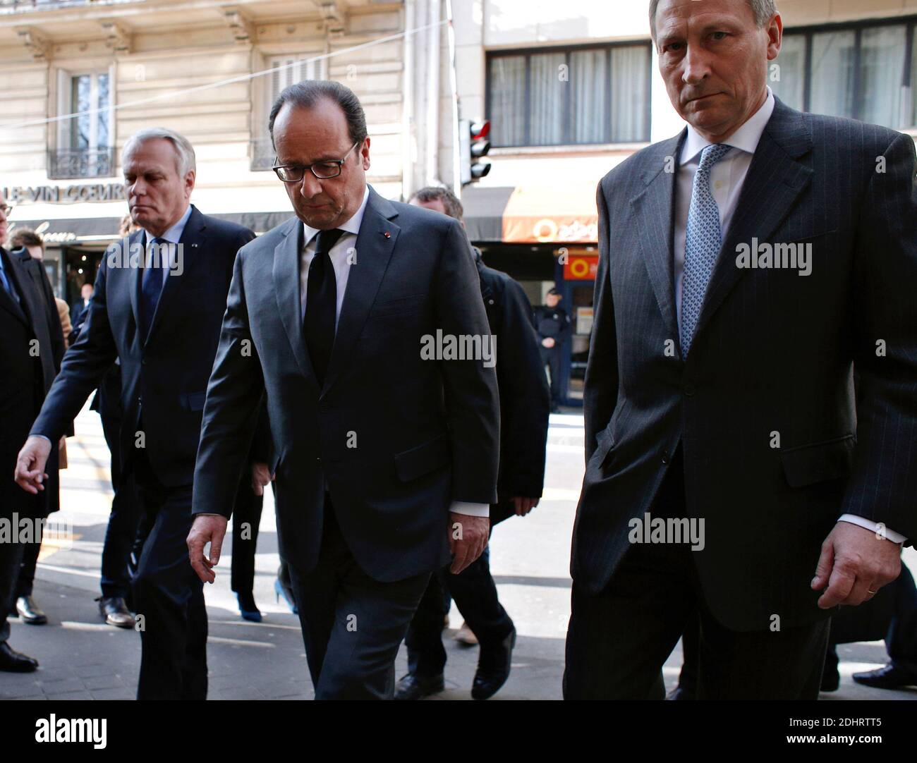 France's President Francois Hollande (C) and Minister of Foreign Affairs and International Development Jean-Marc Ayrault (L) are welcomed by Belgium's Ambassador to France Vincent Mertens de Wilmars as they arrive at the Belgium embassy to pay homage to the victims of the Brussels terror attacks, in Paris, France on Tuesday, March 22, 2016. Bombs exploded at the Brussels airport and one of the city's metro stations earlier today, killing at least 34 and injuring dozens of people. The Islamic State group claimed responsibility for the attacks. Photo by Thibault Camus/Pool/ABACAPRESS.COM Stock Photo