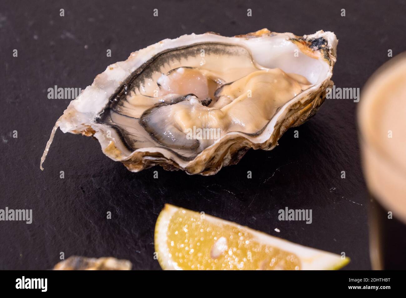 Raw Oyster and Stout with a Lemon Wedge, an Irish Cuisine Speciality Stock Photo