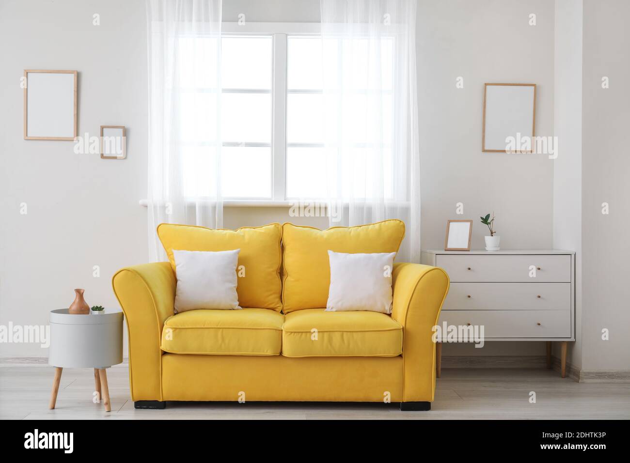 Stylish sofa near window in room Stock Photo Alamy