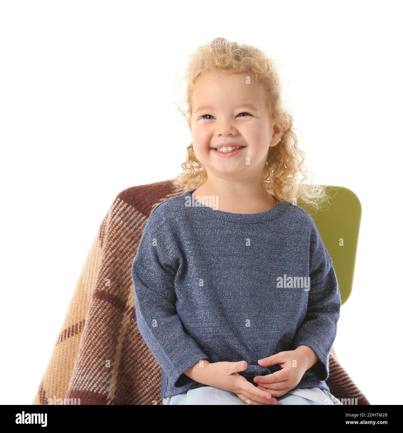 Cute little girl sitting on chair against white background Stock Photo ...