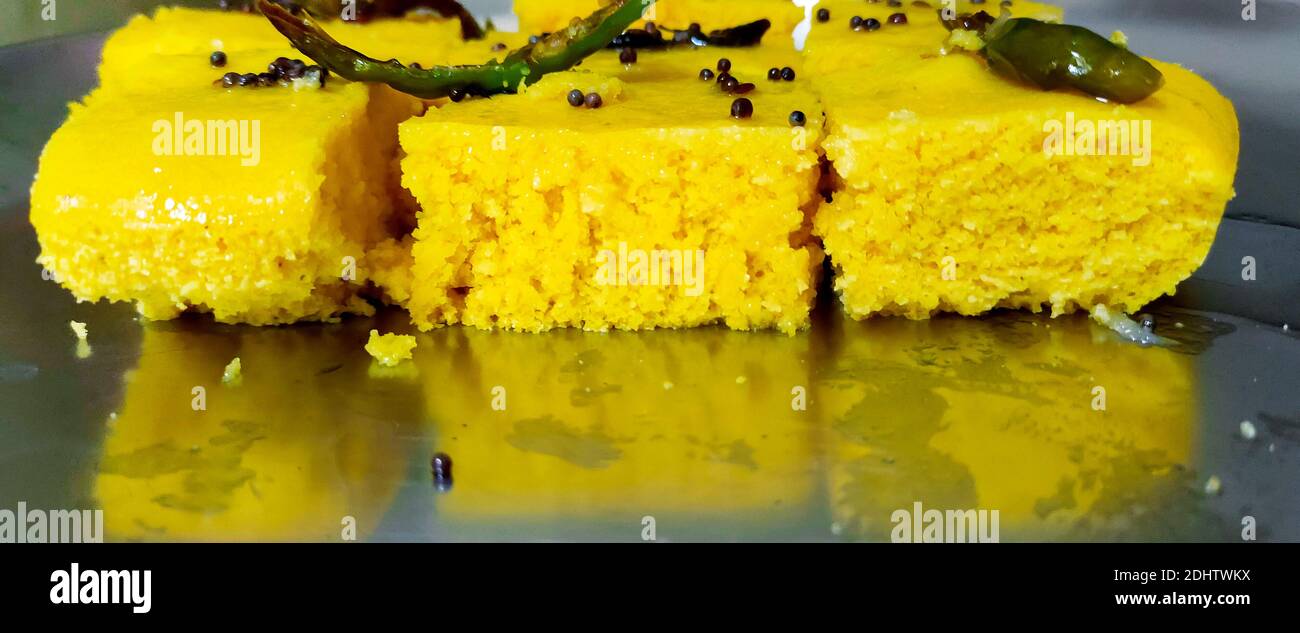 A closup shot of gujarati Khaman Dhokla or Steamed Gram Flour Snack Stock Photo