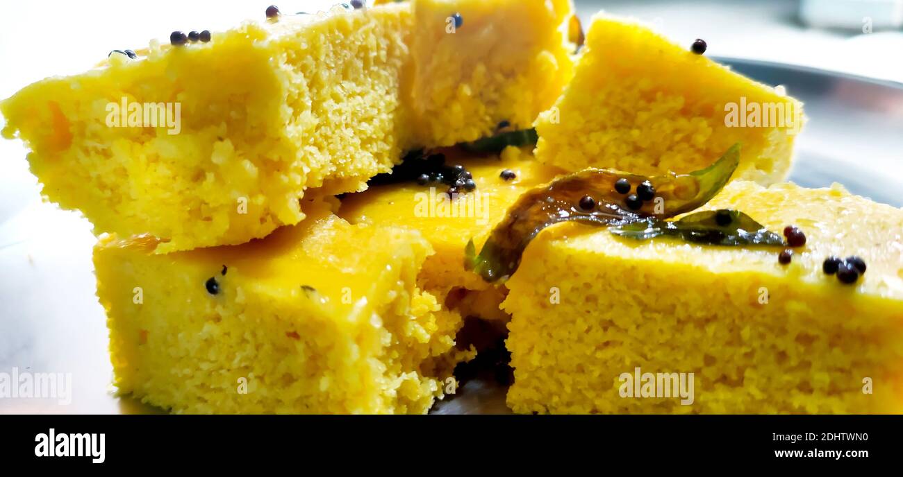 A closup shot of gujarati Khaman Dhokla or Steamed Gram Flour Snack Stock Photo