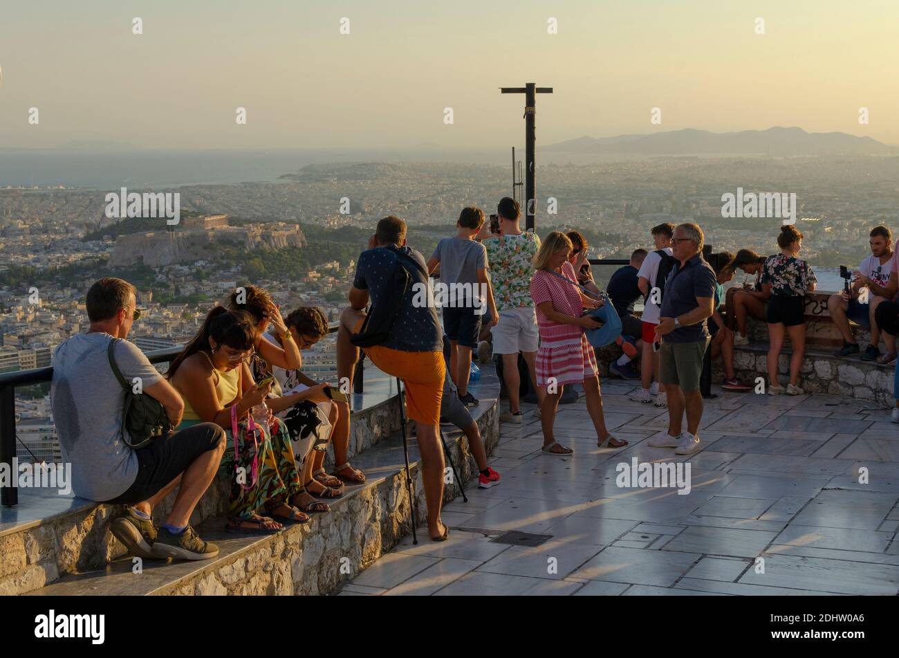 Tourists take snaps on their smartphones at the viewpoint on Lycabettus Hill in central Athens Greece - Photo: Geopix Stock Photo