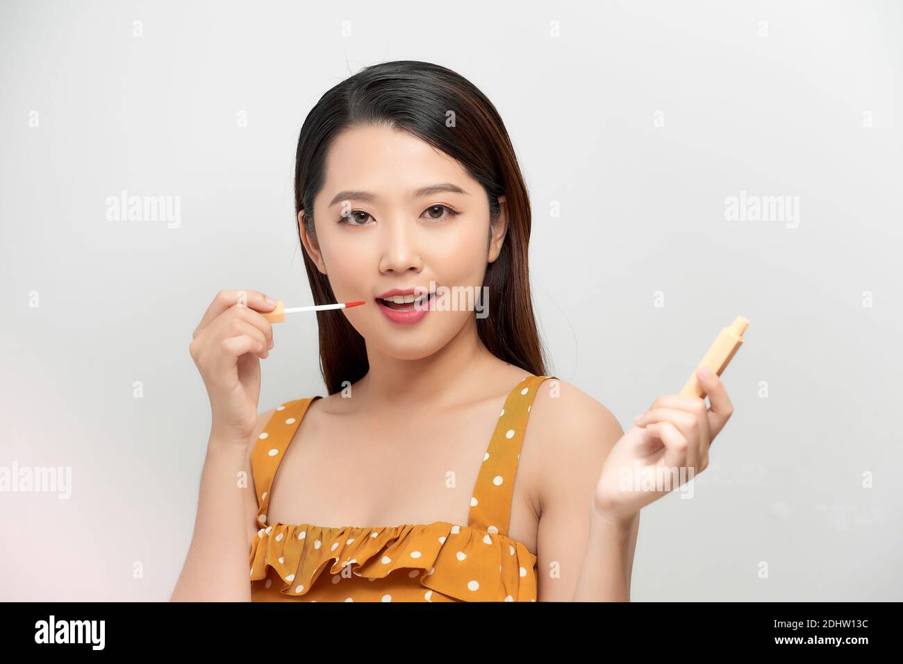 Portrait cheerful attractive young woman have fun, posing red and pink lipsticks isolated white background. Stock Photo