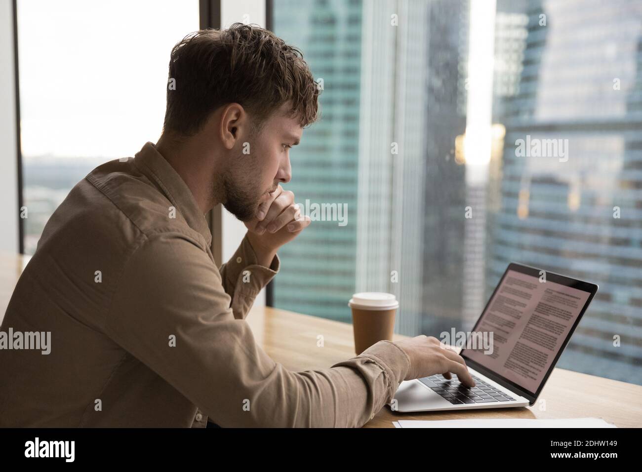 Pensive young man work on laptop thinking Stock Photo
