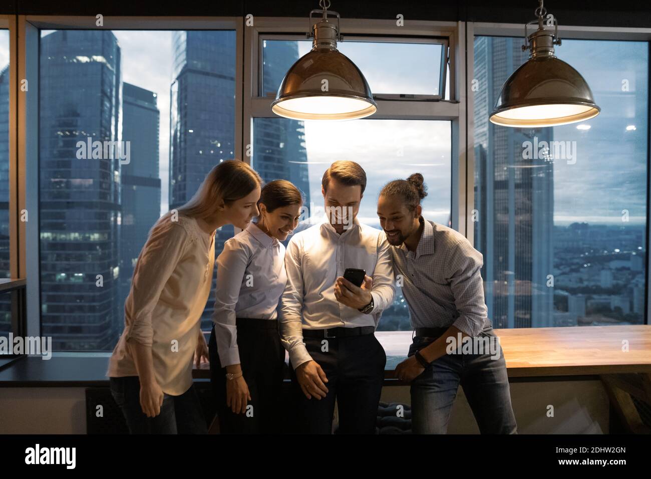 Happy multiracial colleagues have fun in office at night Stock Photo ...