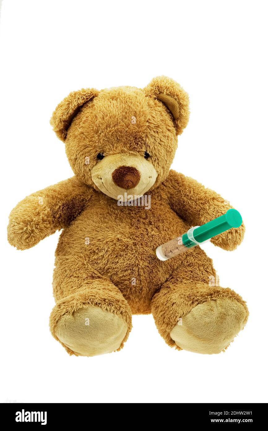 Ein brauner Teddybär bekommt eine Injektion. Impfen und Spritze. Stock Photo