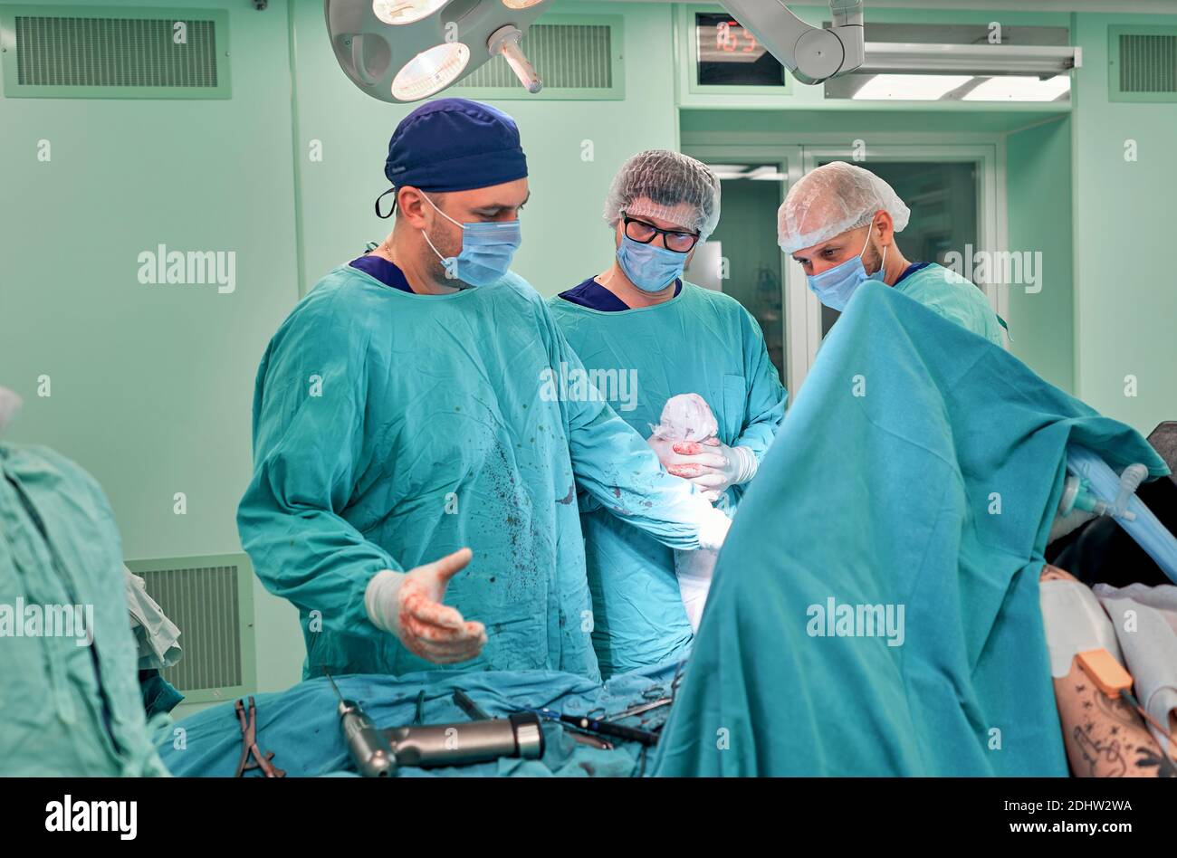 Physicians in Surgery looking down at patient Stock Photo - Alamy