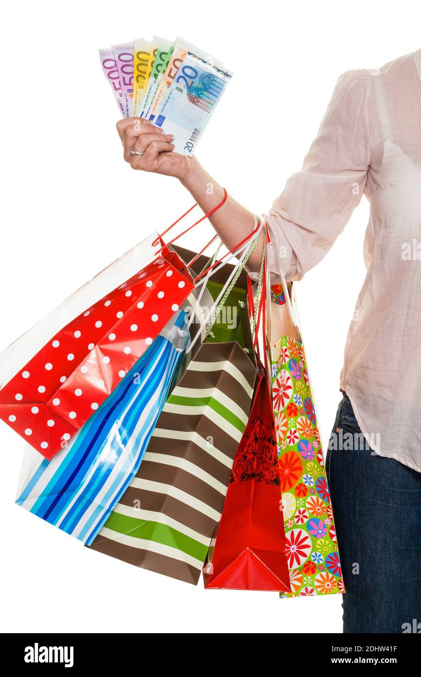 Eine junge Frau kommt mit vielen Einkaufstaschen vom Shopping zurück. Mit Euro Geldscheinen, MR: Yes Stock Photo