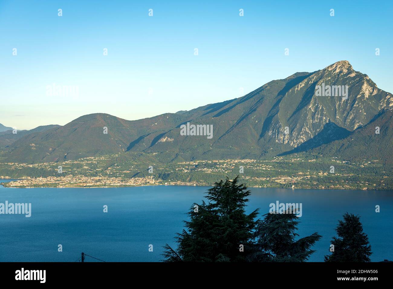 Aerial view of the Lake Garda and Italian Alps with the peak of Monte Pizzocolo and the small town of Toscolano and Maderno. Lombardy coast, Italy. Stock Photo