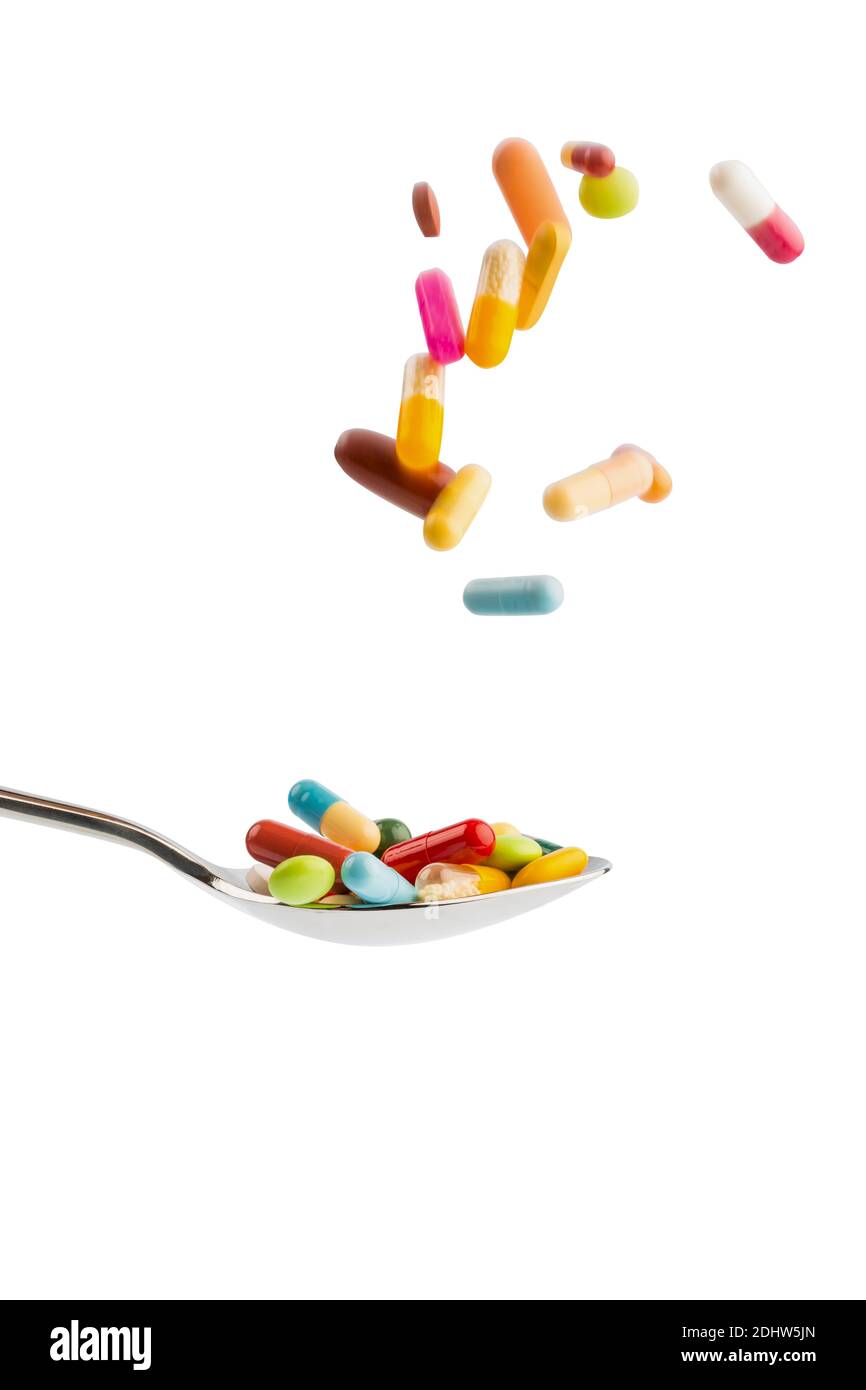 Verschiedene Tabletten, Kosten, Geld, Euro, US-Dollar,Gesundheitswesen, Krankenhasse, Medizin, Pillen, Tabletten fallen auf einen Löffel Stock Photo