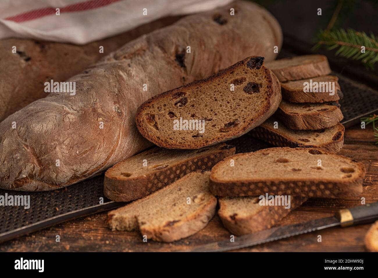 Brown bread with raisins, sliced and whole bread. This traditional swedish christmas bread is made with beer and swedish julmust soda drink. Close up. Stock Photo
