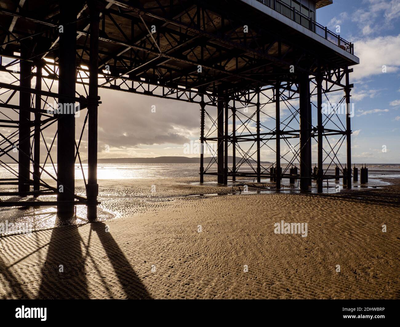 Underneath the Grand Pier at Weston super Mare looking towards Brean Down - Somerset UK Stock Photo