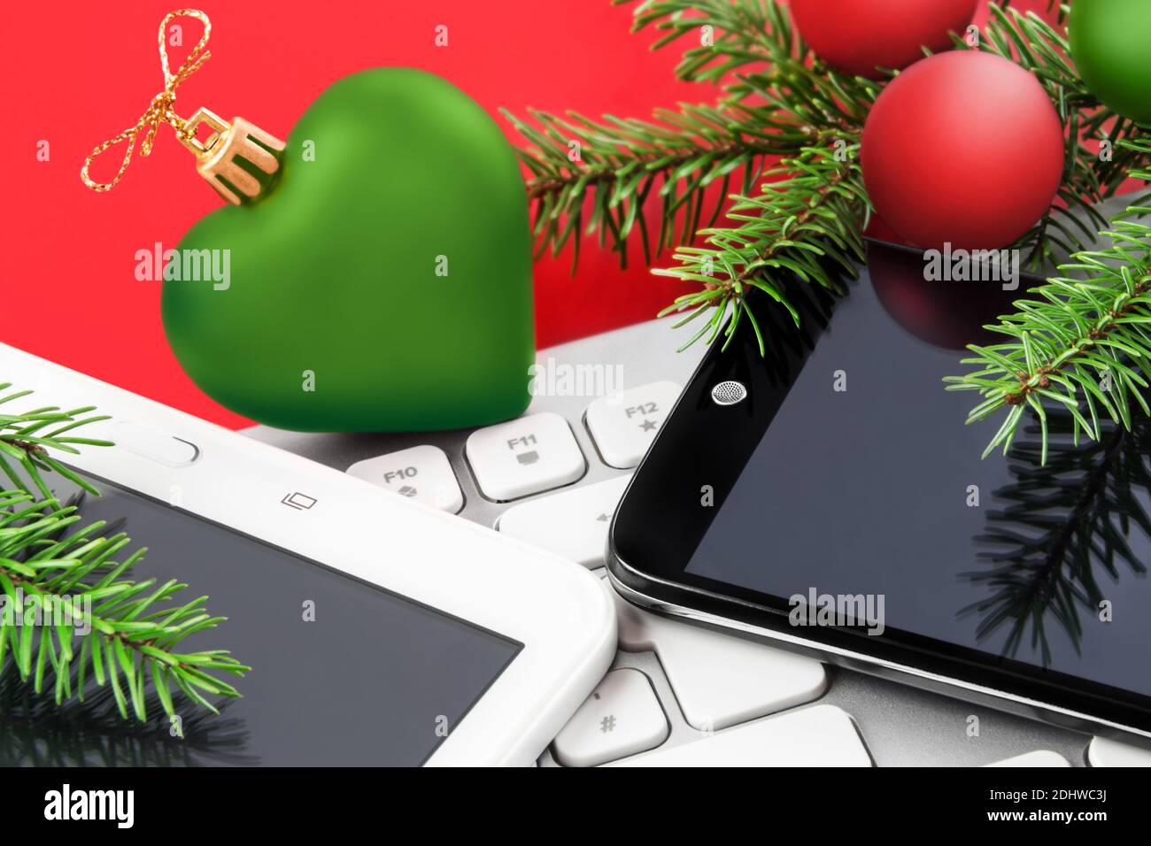 Christmas Time with mobile, and tablet with green heart Stock Photo