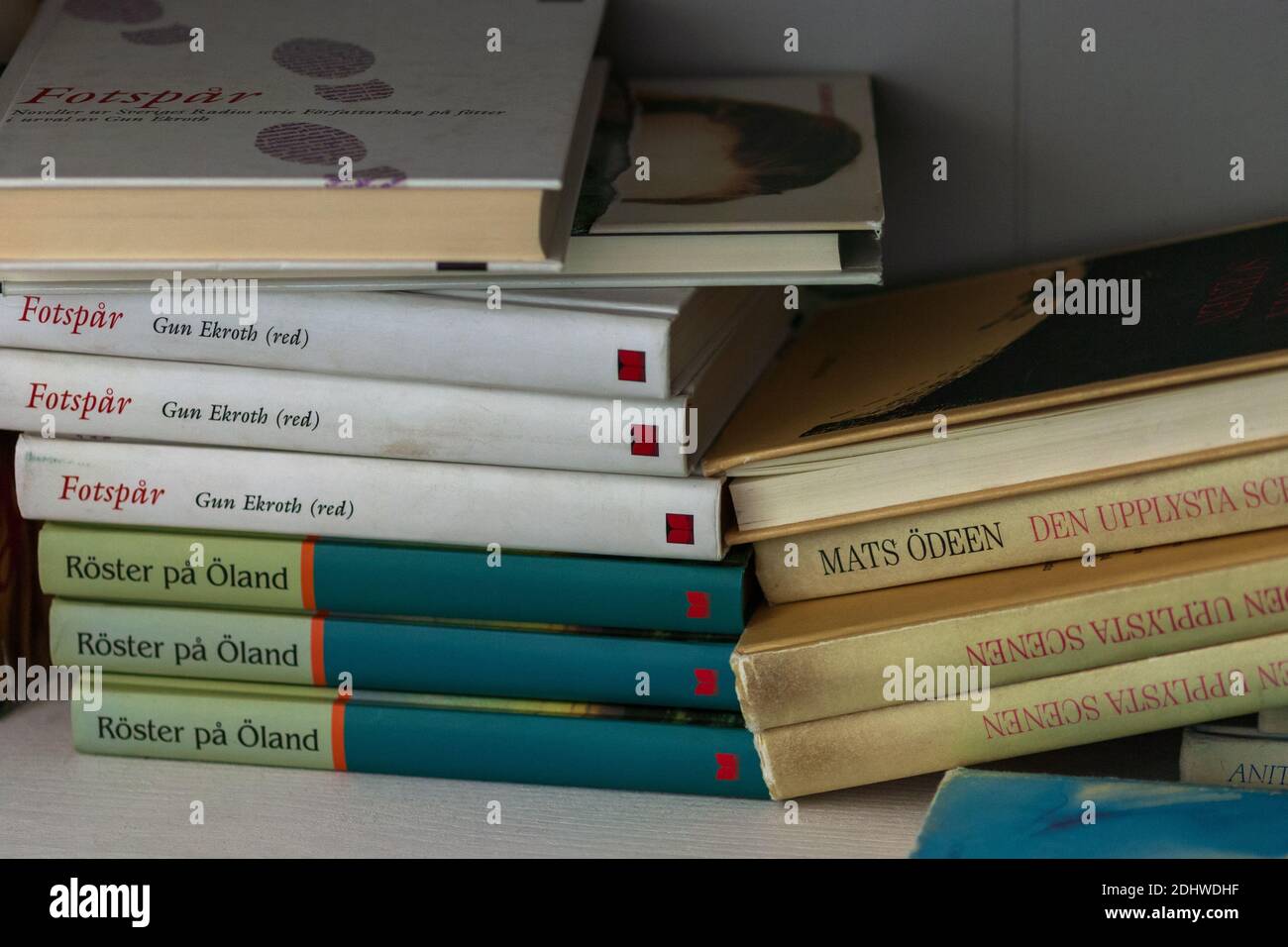 Hardcover books in Swedish piled on bookshelf, Moscow, 01.09.2020 Stock Photo