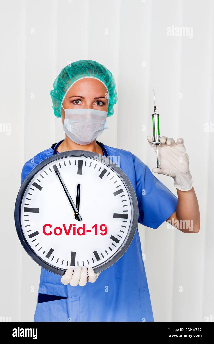 Eine Krankenschwester oder Aerztin in OP- Kleidung vor einer Operation. Symbolfoto fuer arbeiten im Krankenhaus. Uhr 5 vor 12, Stock Photo