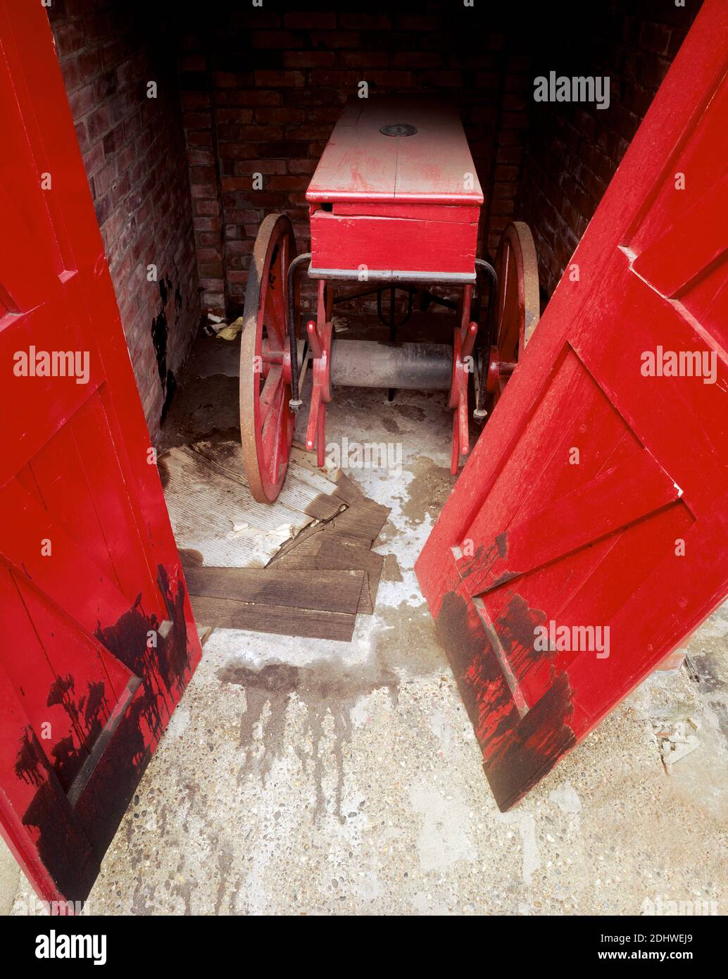 UK, London, Docklands, Isle of Dogs, shipping docks, early 1974. A firefighting handcart with hosereel. The hose would be wrapped around the axle. Stock Photo