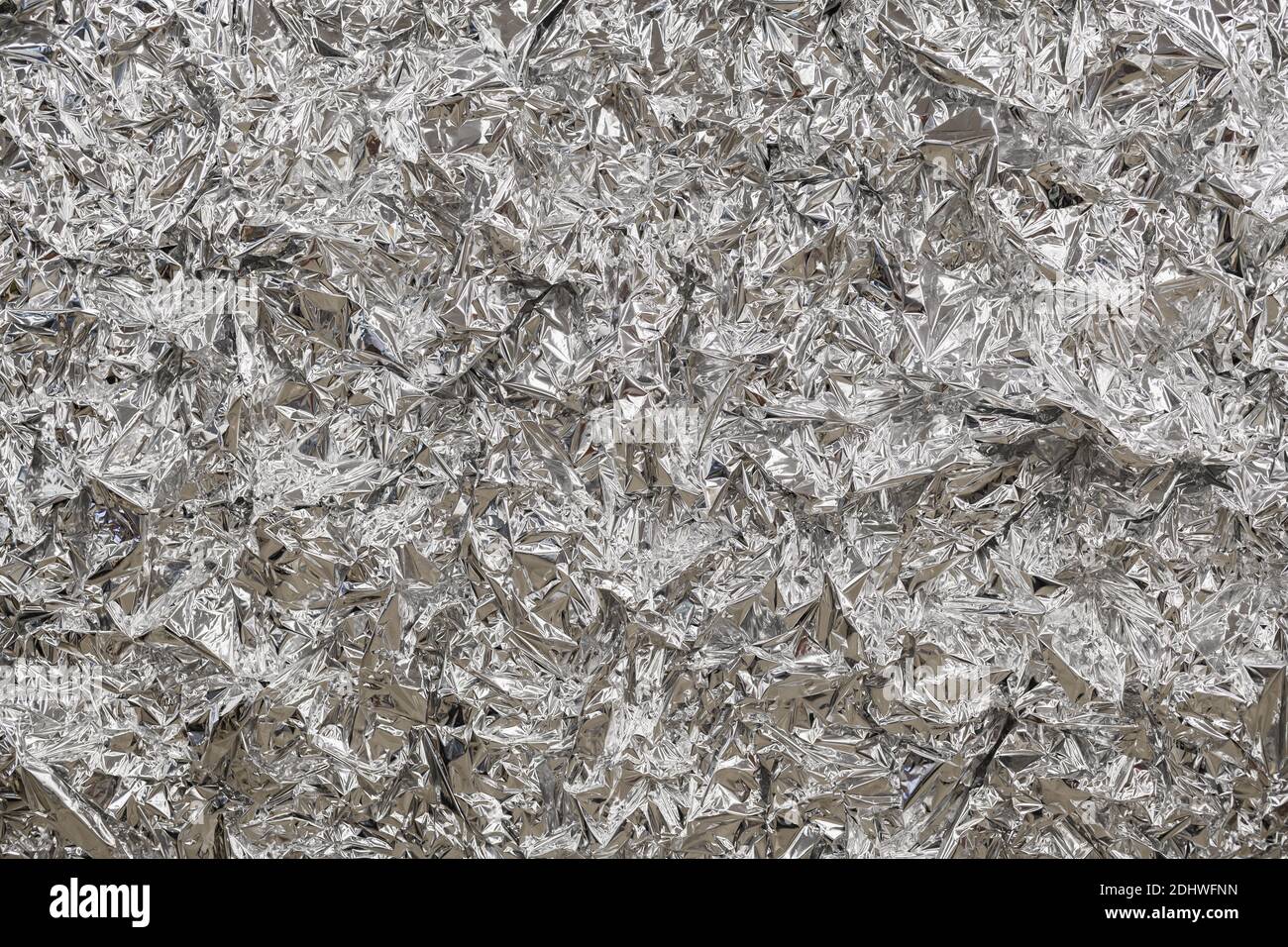 Silver foil background with shiny crumpled surface for texture background Stock Photo