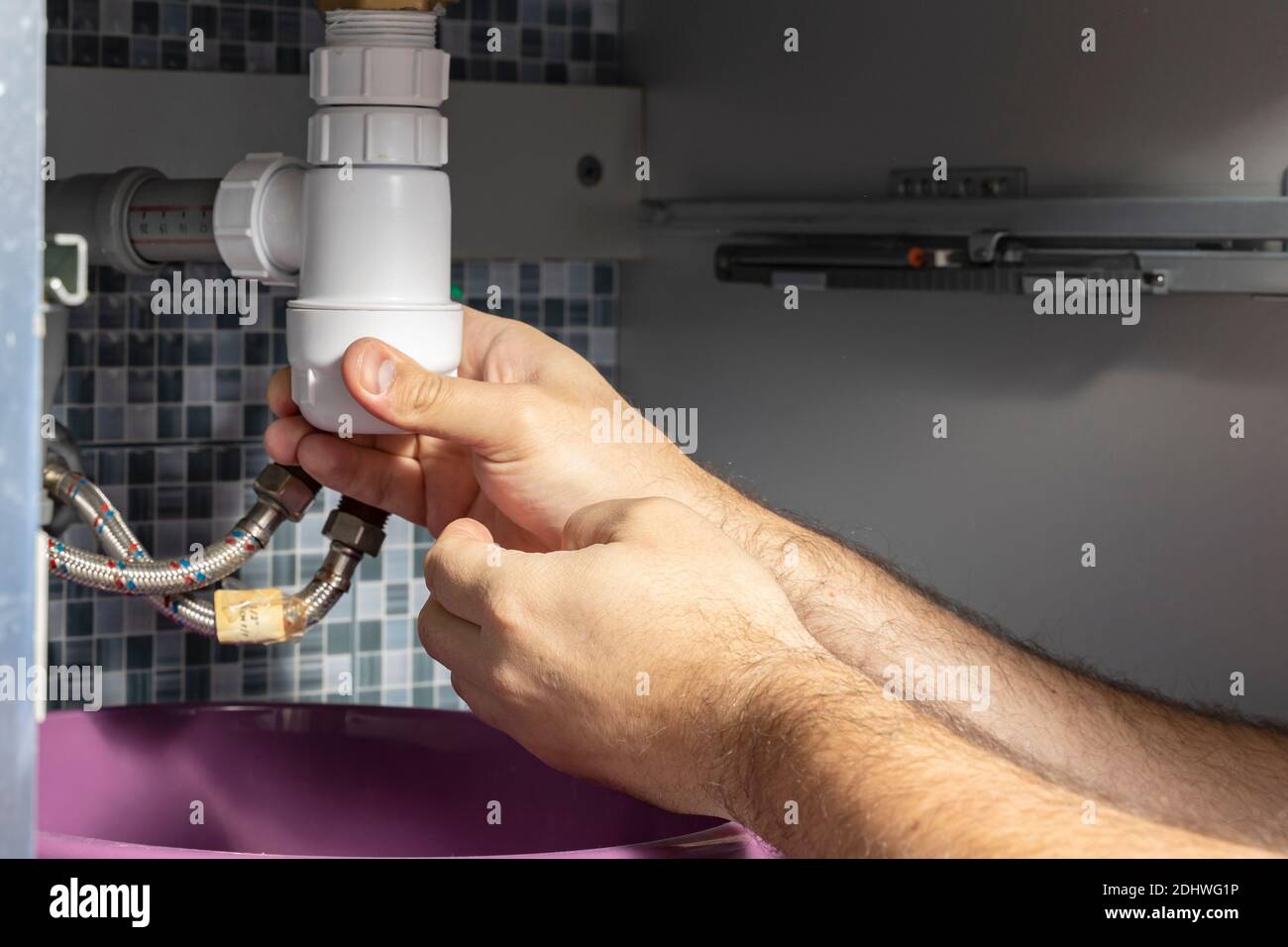 The plumber removes the blockage in the pipes Stock Photo Alamy