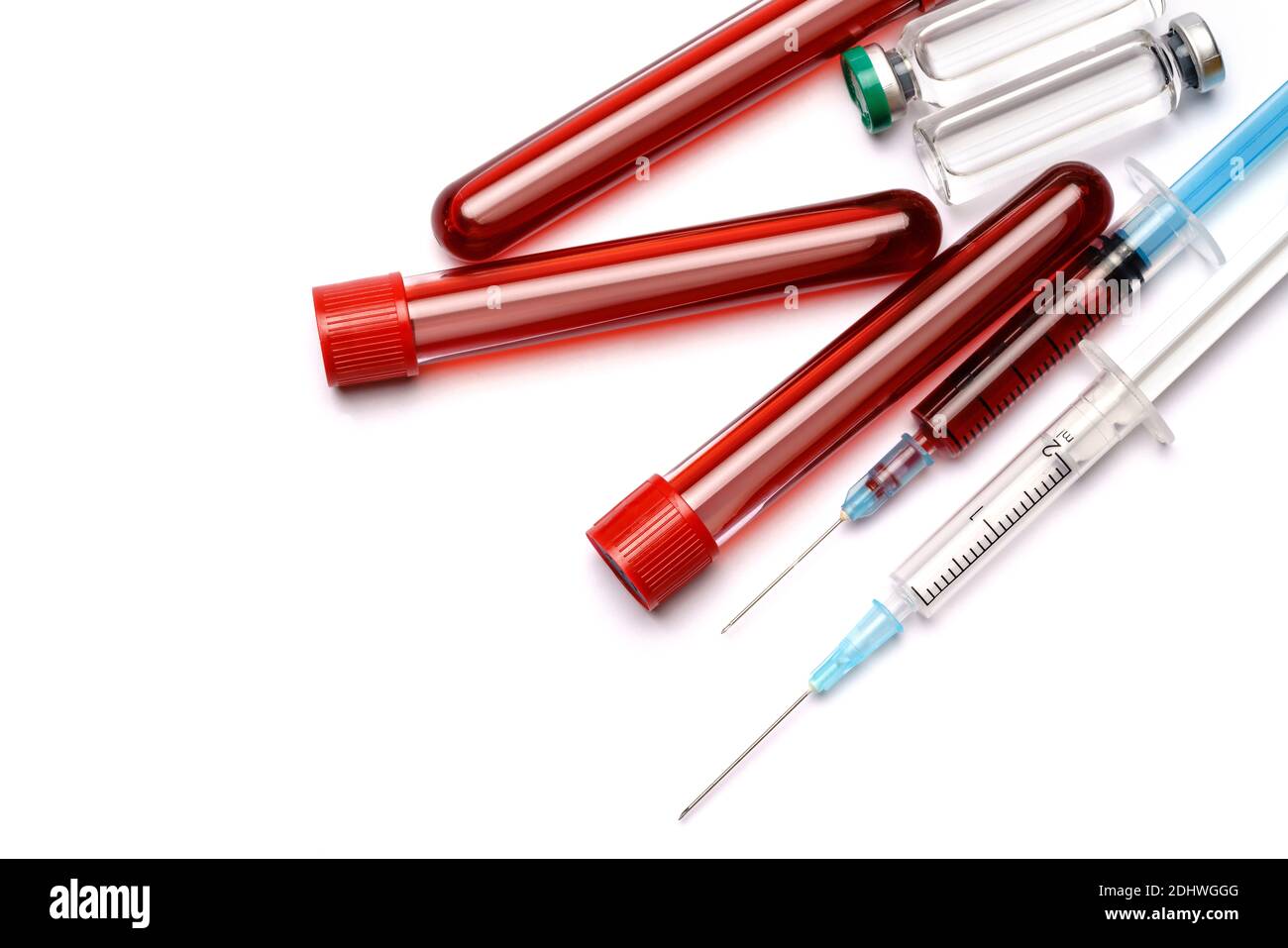 medical ampoule vials, test tubes with blood samples and syringe on light background Stock Photo