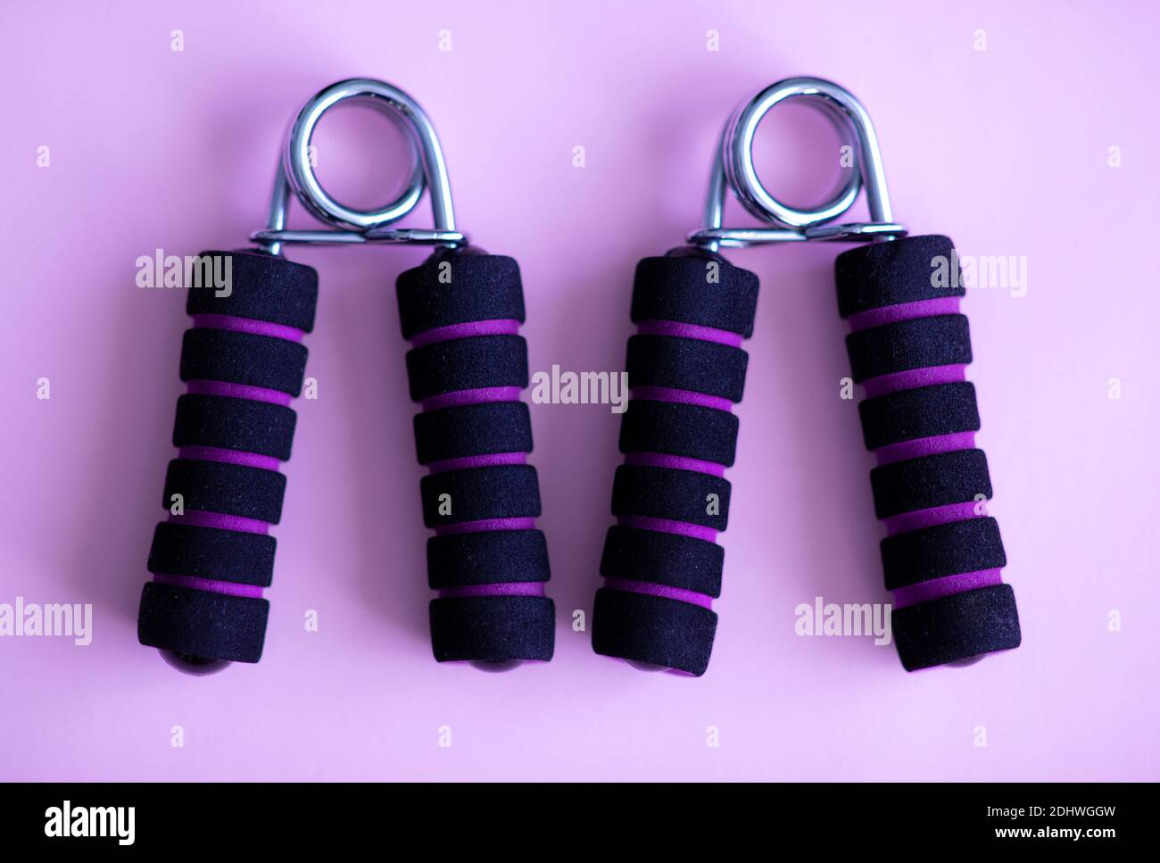 Hand grip strengthener for hand exerciser on a purple background Stock Photo