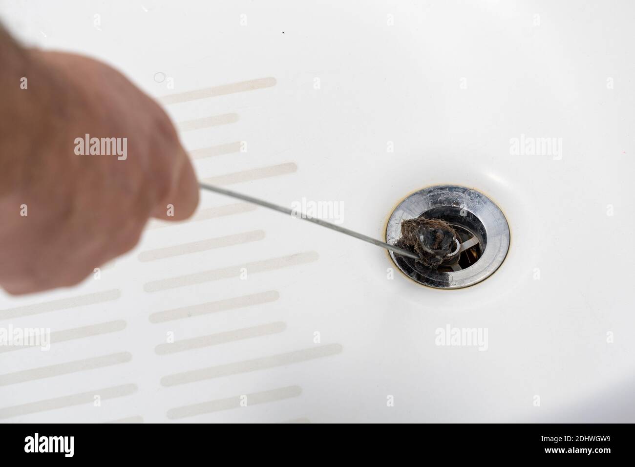 cleaning the clogged bathroom drain Stock Photo Alamy