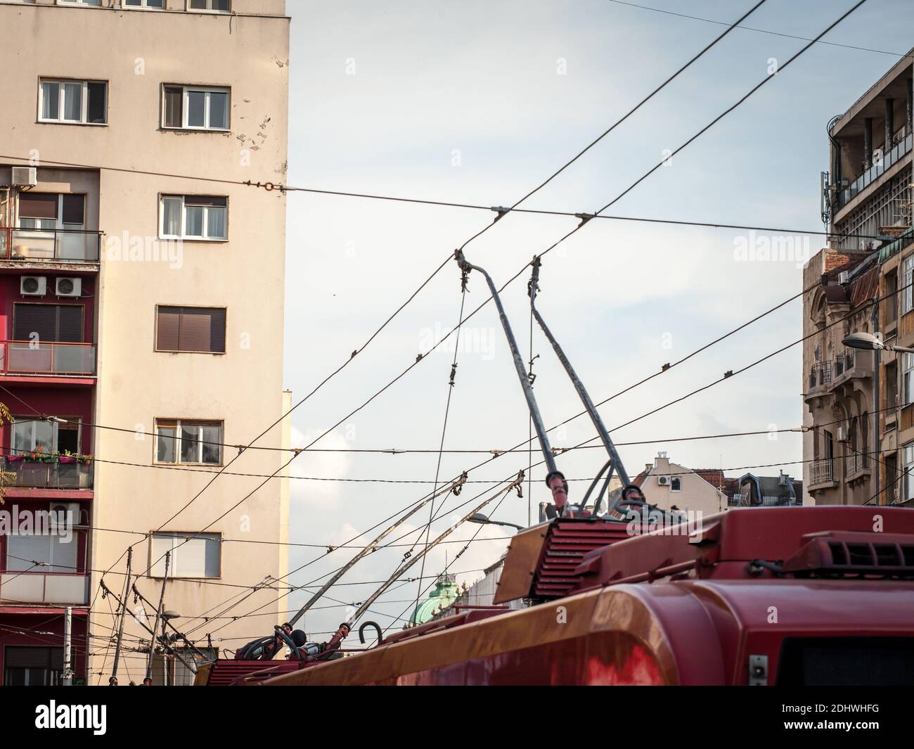 Detail of the power pole and pantograph of a trolleybus connecting the