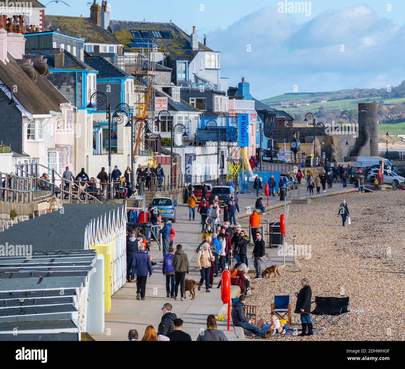 Lyme Regis, Dorset, UK. 12th  December 2020. UK Weather: Bright sunny spells at the coastal resort town of Lyme Regis. Locals and visitors enjoy a bright and chilly day by the sea ahead of rain showers forecast later in the day Credit: Celia McMahon/Alamy Live News. Stock Photo