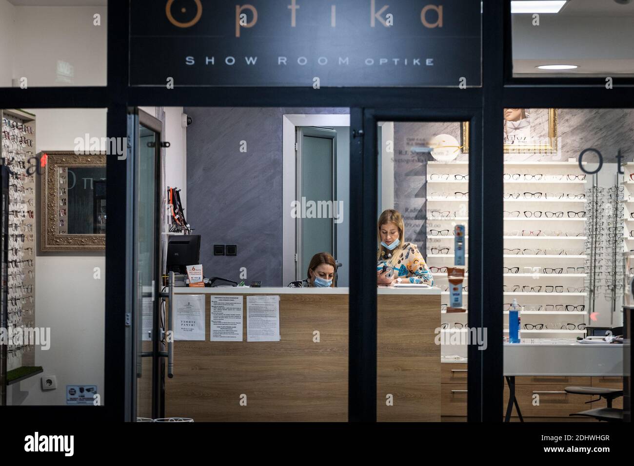 BELGRADE, SERBIA - OCTOBER 26, 2020: Women staff emplyees workers wearing a respiratory face mask in an optician store in Belgrade, during the coronav Stock Photo
