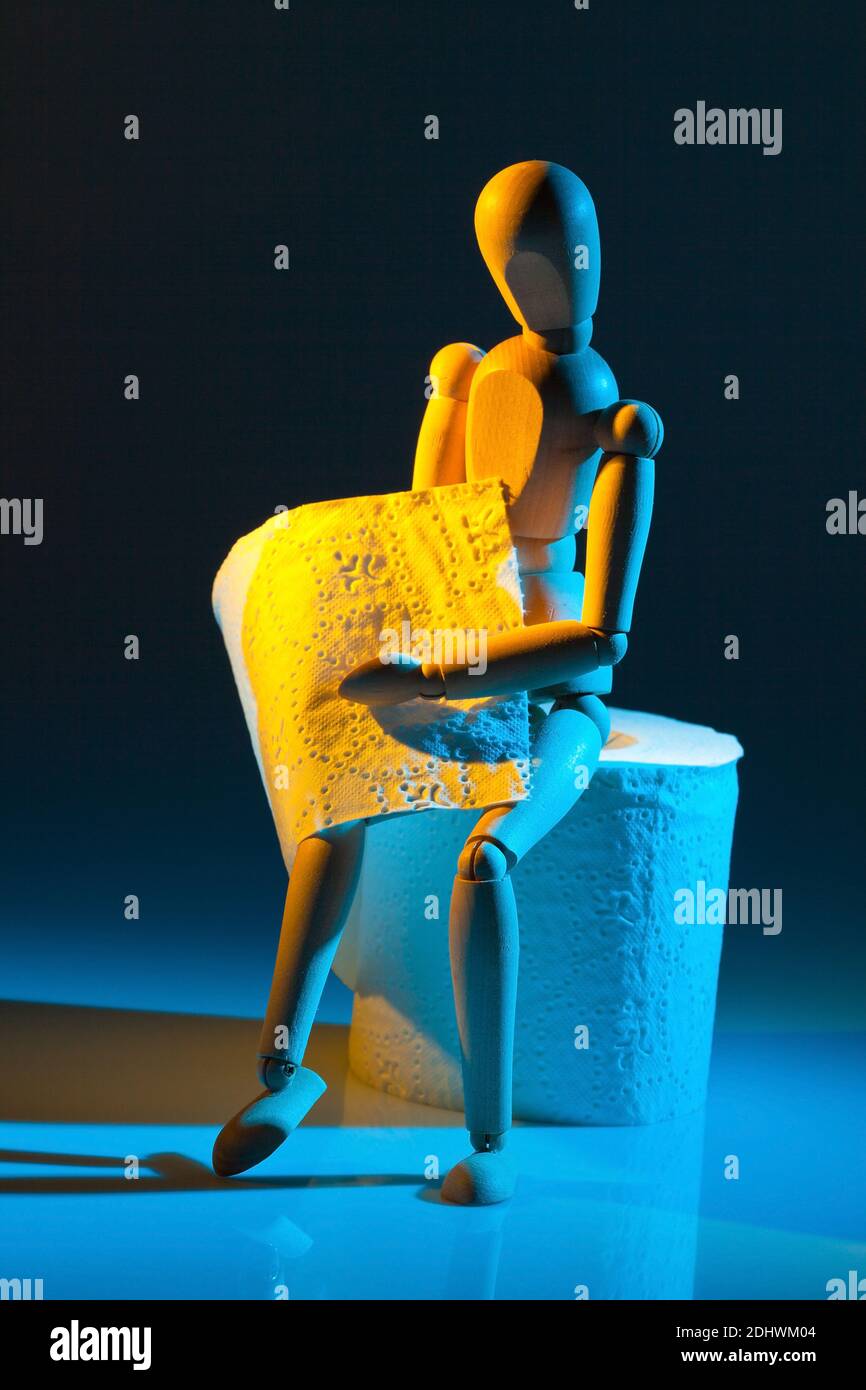 Eine Figur mit Toiletten Papier. Symbolphoto für Darmerkrankung Stock Photo