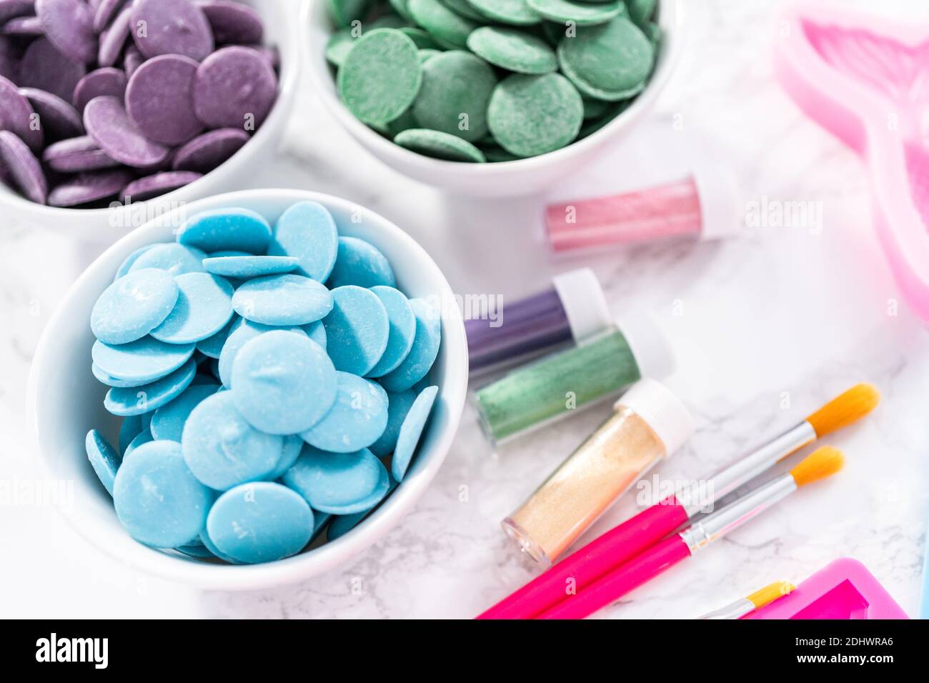 Flat lay. Ingredients to make chocolate mermaid molds from the chocolate chips. Stock Photo