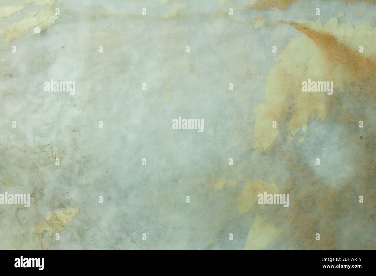 Dirty glass background with traces of glued paper. Grunge texture. Stock Photo