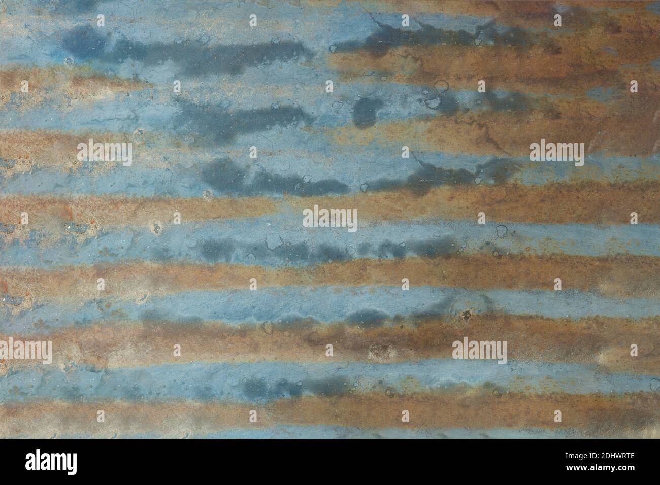 Blue painted sheet metal worn and dirty with rust. Texture background. Stock Photo