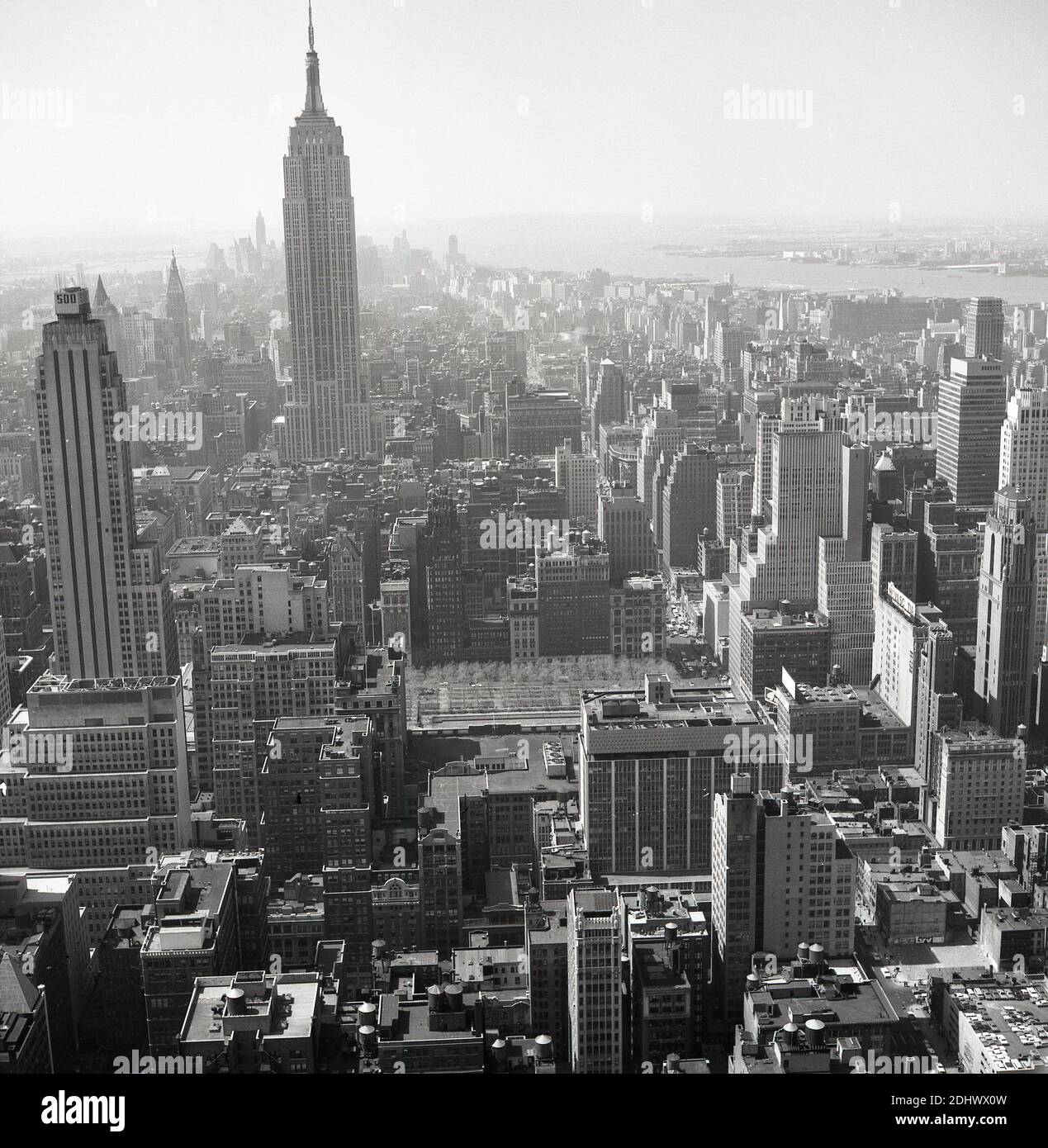 1960s, historical aerial view over Manhattan, New York city, showing the Tower blocks and skyscrapers. Stock Photo