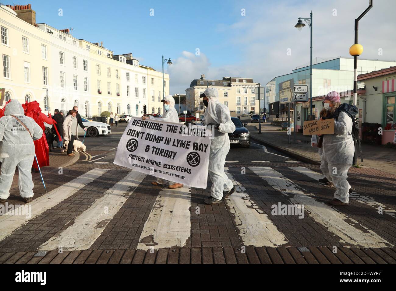 Teignmouth, South Devon, UK. 12th Dec, 2020. Members of Ocean Rebellion XR and the Red Rebels staged a peaceful protest in the seaside resort of Teignmouth. Protestors are calling for sludge dumping from Exmouth Docks to be stopped from dumping 10,000 tons of pollutants into an area of the sea where juvenile fish are developing.Locals feel angry that the sludge dumping took place during the lock down when protests could not legally take place. Credit: Natasha Quarmby/Alamy Live News Stock Photo