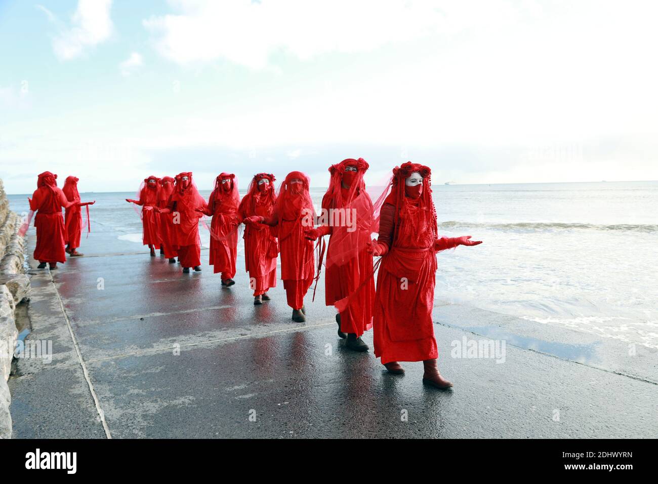 Teignmouth, South Devon, UK. 12th Dec, 2020. Members of Ocean Rebellion XR and the Red Rebels staged a peaceful protest in the seaside resort of Teignmouth. Protestors are calling for sludge dumping from Exmouth Docks to be stopped from dumping 10,000 tons of pollutants into an area of the sea where juvenile fish are developing.Locals feel angry that the sludge dumping took place during the lock down when protests could not legally take place. Credit: Natasha Quarmby/Alamy Live News Stock Photo