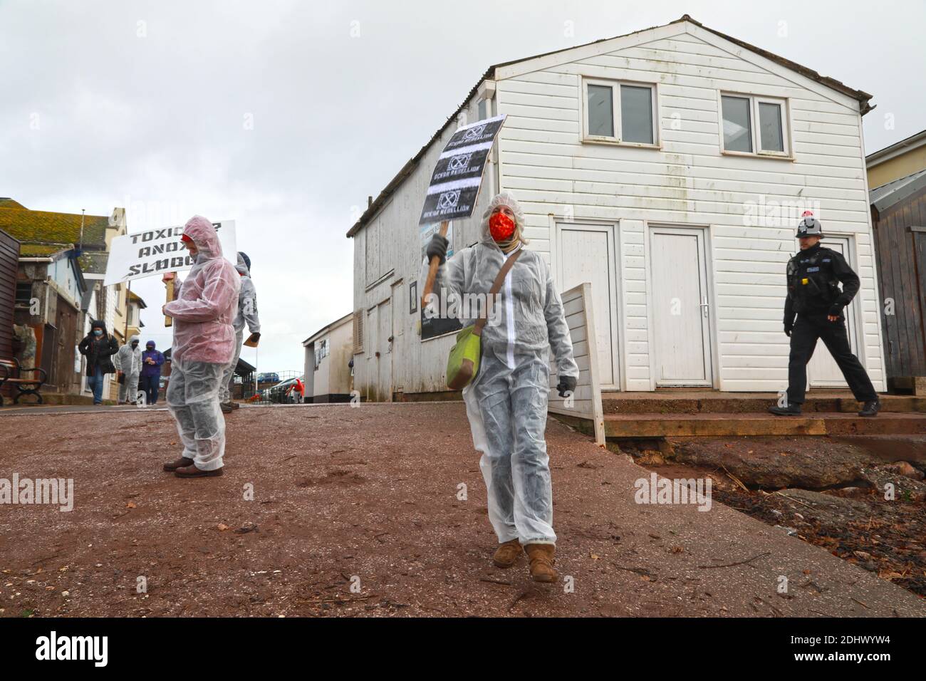 Teignmouth, South Devon, UK. 12th Dec, 2020. Members of Ocean Rebellion XR and the Red Rebels staged a peaceful protest in the seaside resort of Teignmouth. Protestors are calling for sludge dumping from Exmouth Docks to be stopped from dumping 10,000 tons of pollutants into an area of the sea where juvenile fish are developing.Locals feel angry that the sludge dumping took place during the lock down when protests could not legally take place. Credit: Natasha Quarmby/Alamy Live News Stock Photo