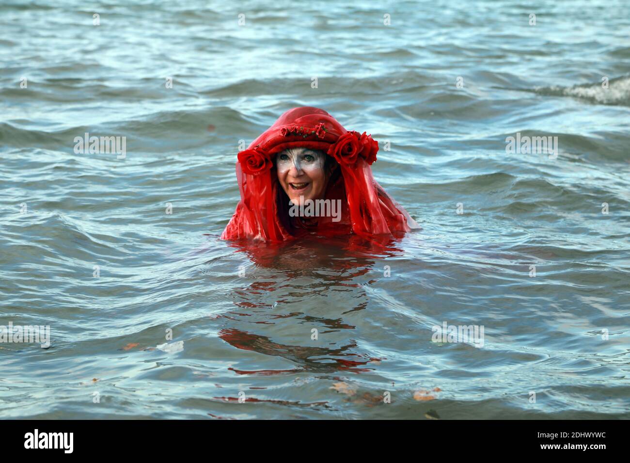 Teignmouth, South Devon, UK. 12th Dec, 2020. Members of Ocean Rebellion XR and the Red Rebels staged a peaceful protest in the seaside resort of Teignmouth. Protestors are calling for sludge dumping from Exmouth Docks to be stopped from dumping 10,000 tons of pollutants into an area of the sea where juvenile fish are developing.Locals feel angry that the sludge dumping took place during the lock down when protests could not legally take place. Credit: Natasha Quarmby/Alamy Live News Stock Photo