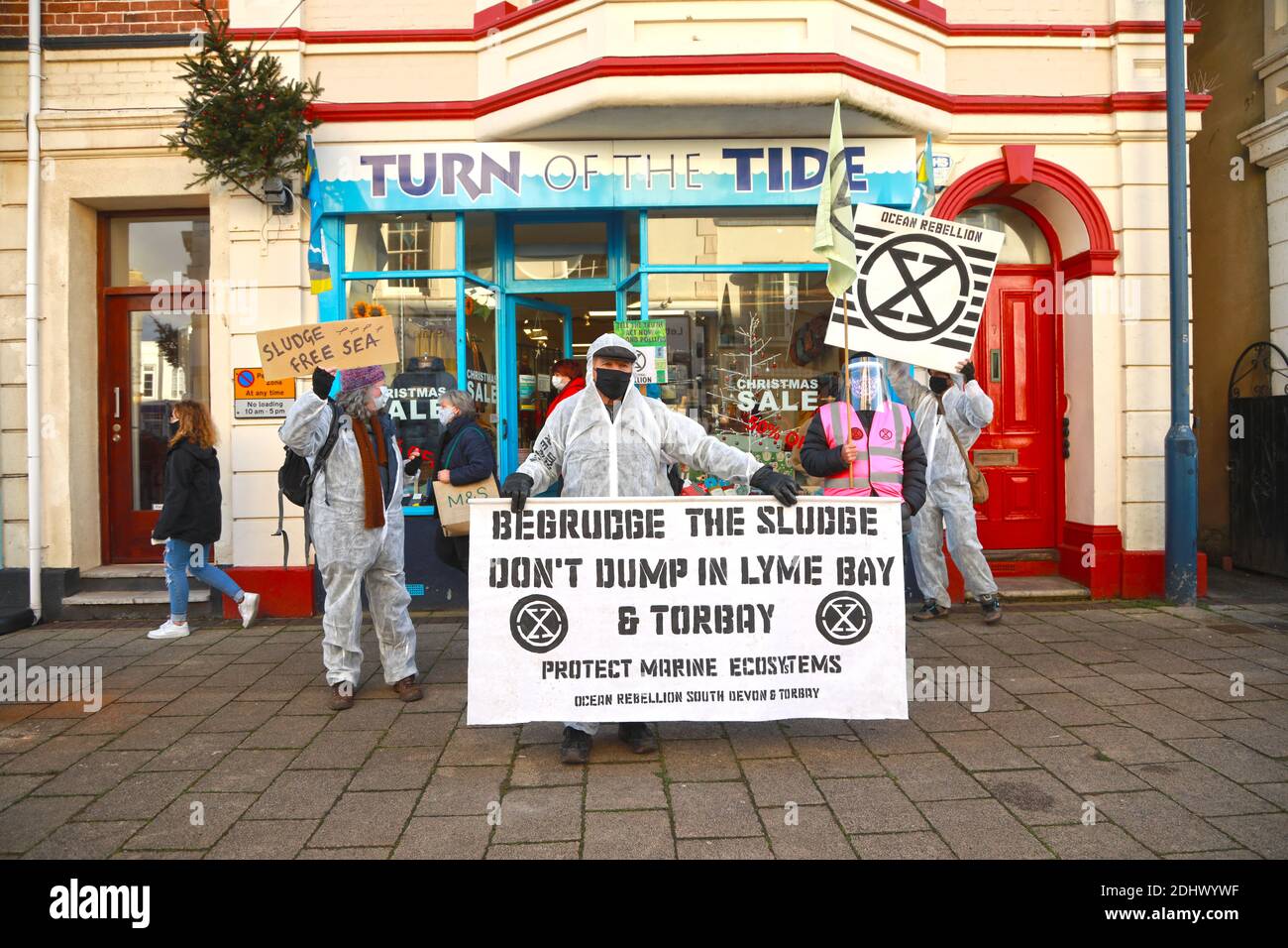 Teignmouth, South Devon, UK. 12th Dec, 2020. Members of Ocean Rebellion XR and the Red Rebels staged a peaceful protest in the seaside resort of Teignmouth. Protestors are calling for sludge dumping from Exmouth Docks to be stopped from dumping 10,000 tons of pollutants into an area of the sea where juvenile fish are developing.Locals feel angry that the sludge dumping took place during the lock down when protests could not legally take place. Credit: Natasha Quarmby/Alamy Live News Stock Photo